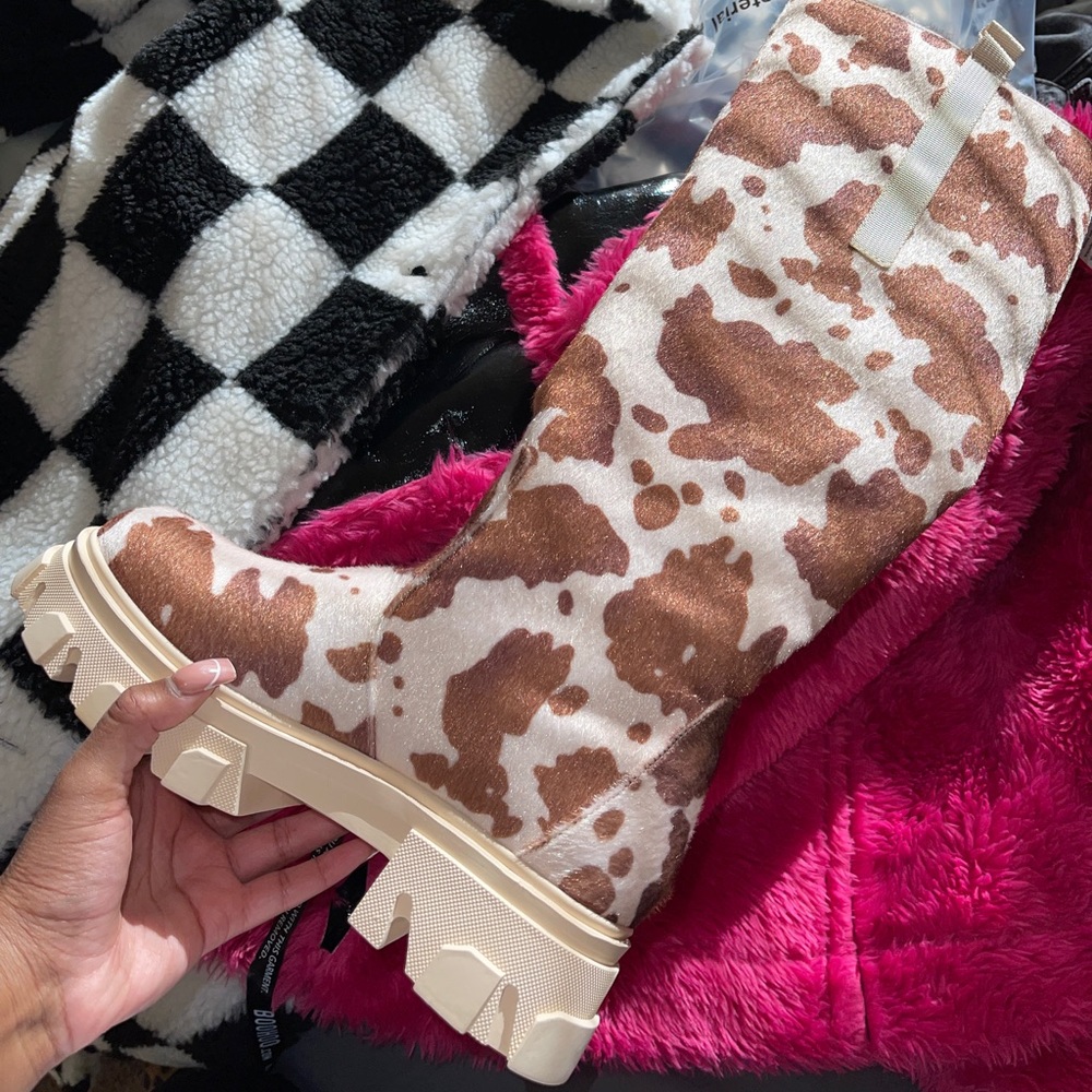 Cow print knee high boots